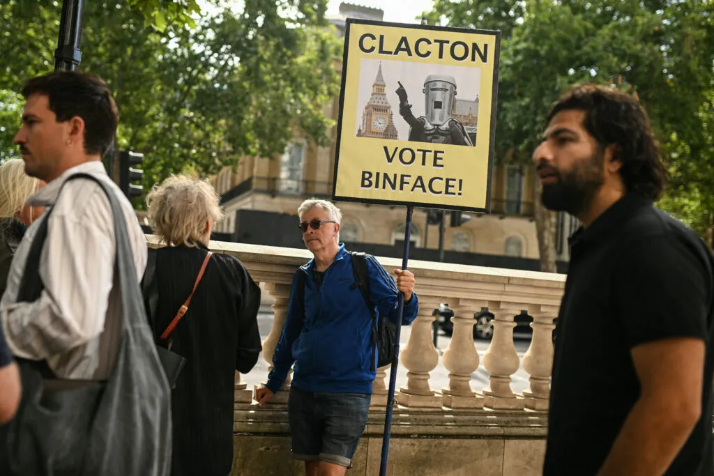 Crowd outside Downing Street referencing the Aug. 13 Clacton by-election, where Farage faces Count Binface