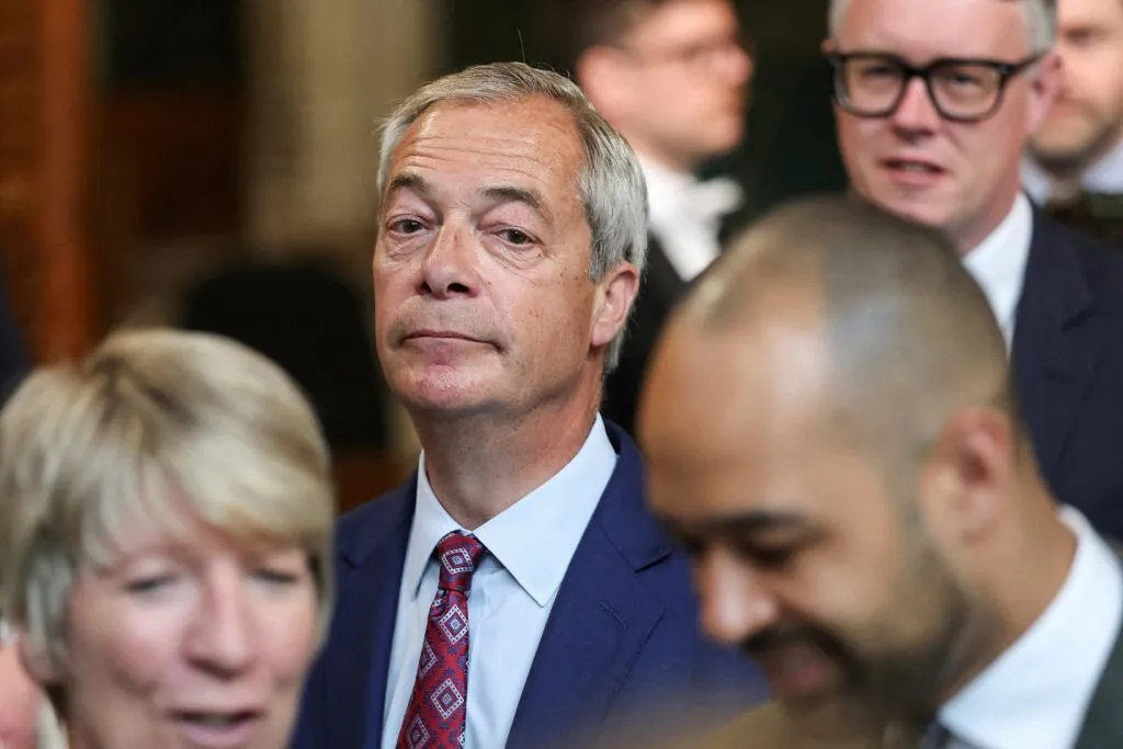 Farage walking through the House of Commons, underscoring his central role in the party’s ambitions