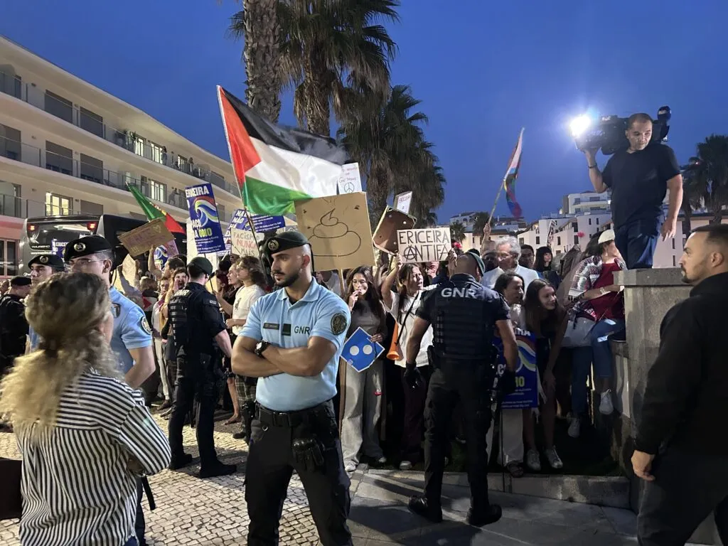 Residents and antifascist activists protest outside the Patriots’ event venue.